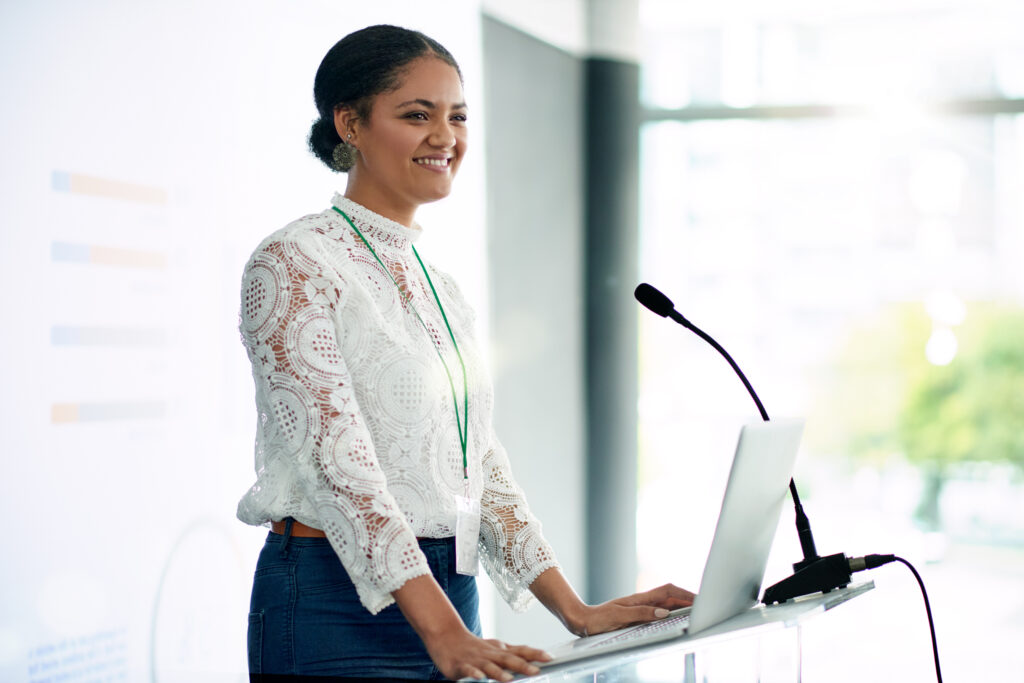 Shot of a young minority businesswoman delivering her WordCamp presentation 